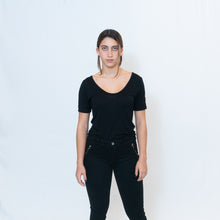 Load image into Gallery viewer, Deep scoop neck black t-shirt with Ari Arteaga&#39;s red heart on the left shoulder
