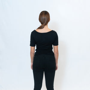 Rear View Deep scoop neck black t-shirt with Ari Arteaga's red heart on the left shoulder