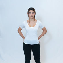 Load image into Gallery viewer, Deep scoop neck white t-shirt with Ari Arteaga&#39;s red heart on the left shoulder
