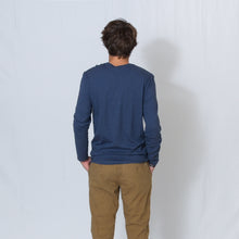 Load image into Gallery viewer, Rear View Heather Navy Crew Neck Long Sleeve T-shirt with Ari&#39;s Heart and Be the Light in Red on the Left Shoulder
