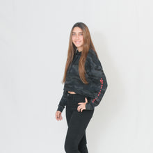 Load image into Gallery viewer, Stylish black camo print cropped hoodie with Be the Light written in red on the sleeve
