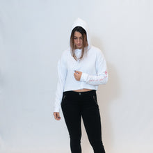 Load image into Gallery viewer, Simple white cropped hoodie with Be the Light written in red on the sleeve
